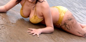 Attractive female model in bikini on the beach